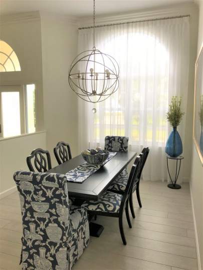 Sheer curtains and drapery rod in dining room