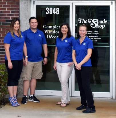 The Shade Shop Company Picture, Three women and one man wearing blue shirts